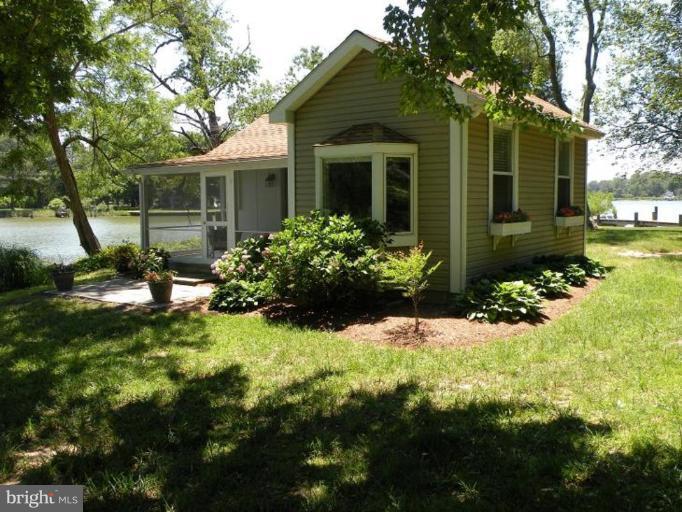 6857 Edge Creek Road St. Michaels, MD 21663 - Photo 10 of 13 a front view of a house with garden
