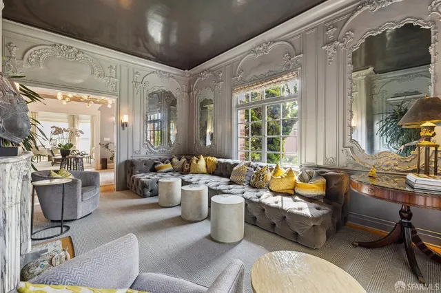 a view of a dining room with furniture a chandelier and a window