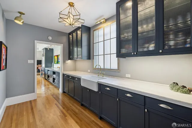 a kitchen with stainless steel appliances granite countertop lots of counter top space and wooden floor