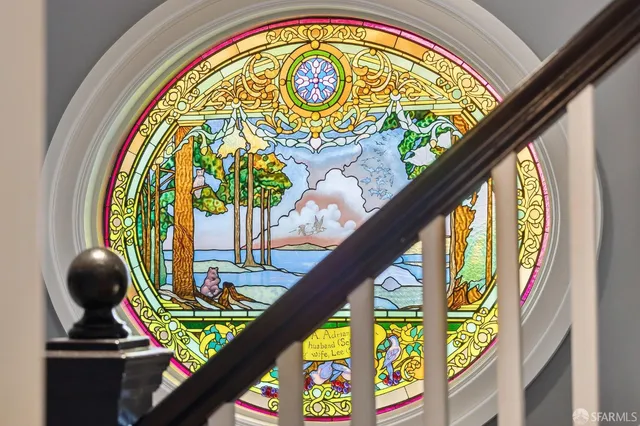 a bedroom with furniture and a large window