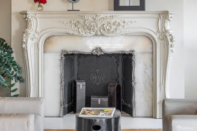 a living room with furniture and a view of kitchen