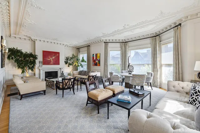 a dining room with furniture potted plants and a fireplace