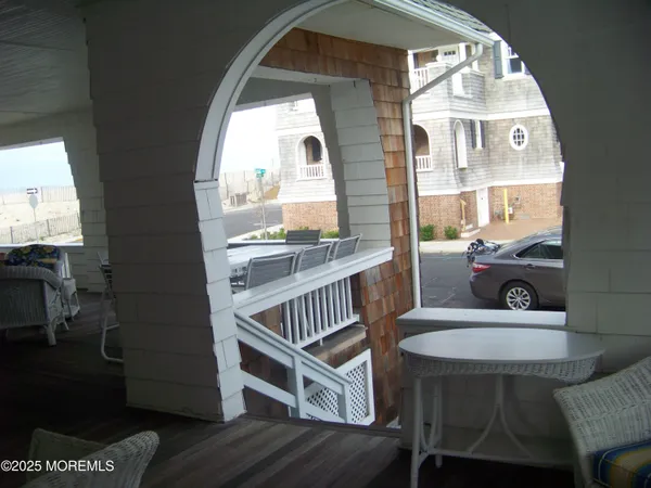 a view of a livingroom with furniture wooden floor and a floor to ceiling window