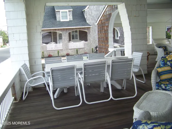 a dining room with furniture and wooden floor