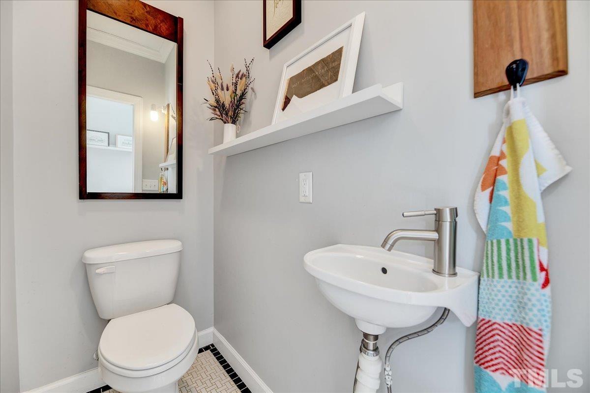 800 Hartford Road Raleigh, NC 27610 - Photo 16 of 28 a bathroom with a toilet sink and mirror