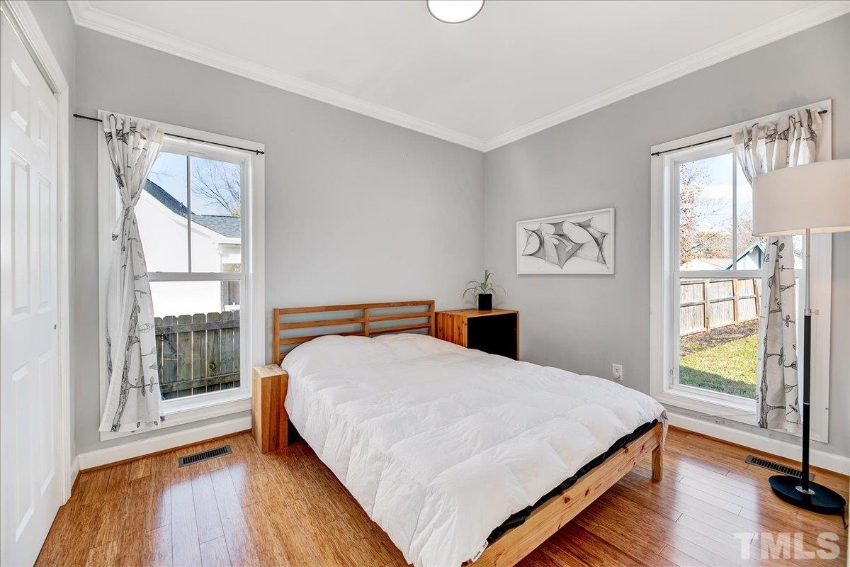 800 Hartford Road Raleigh, NC 27610 - Photo 18 of 28 a bed sitting in a bedroom next to a window