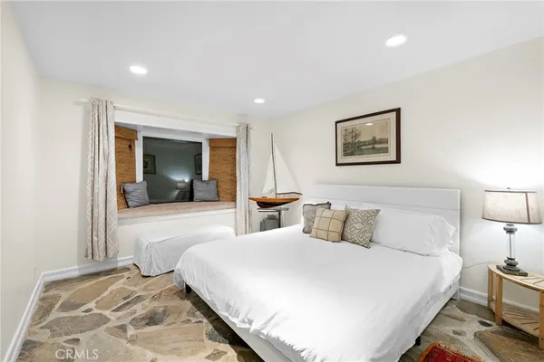 a bedroom with a large bed and a lamp