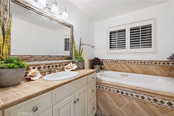 a bathroom with a granite countertop bathtub and a sink