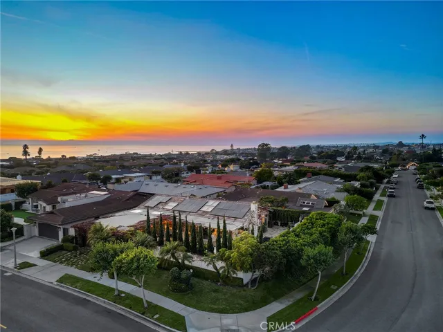 an aerial view of residential houses with outdoor space and trees