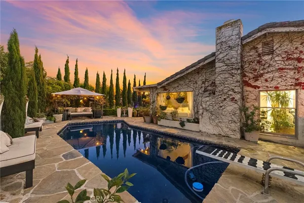 a terrace with outdoor seating and trees