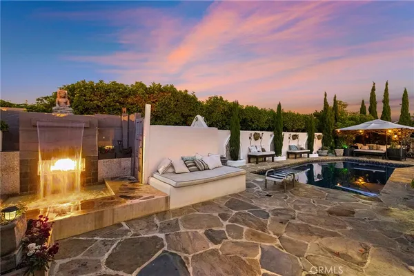 a view of a patio with swimming pool and sitting area