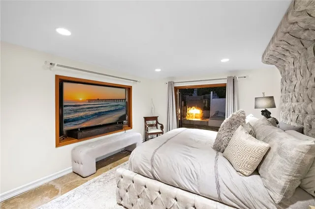 a bedroom with a bed and a flat screen tv