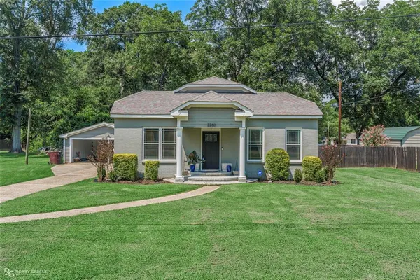 a front view of a house with a yard and porch