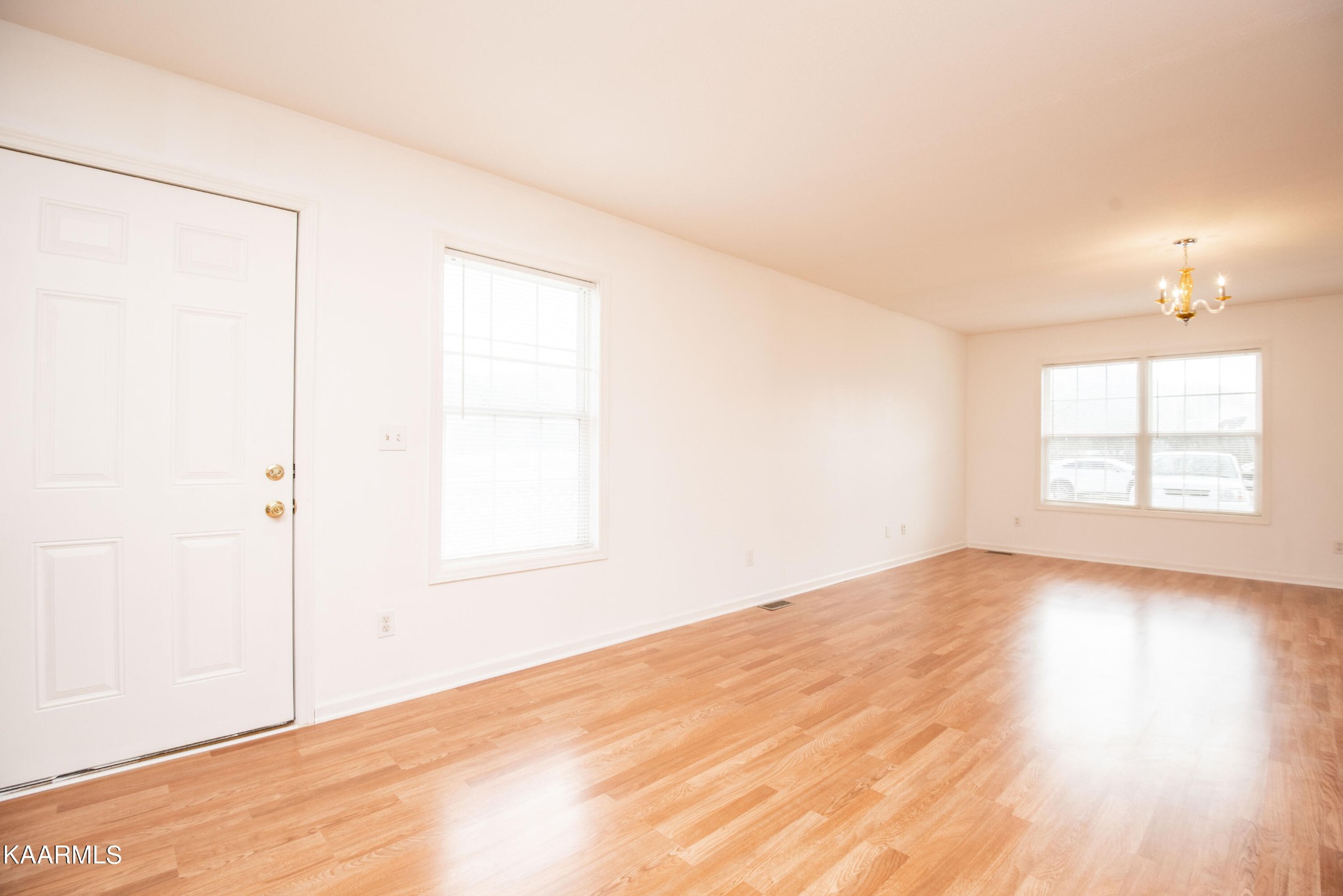 122 Donahue Road Luttrell, TN 37779 - Photo 5 of 19 an empty room with wooden floor and windows