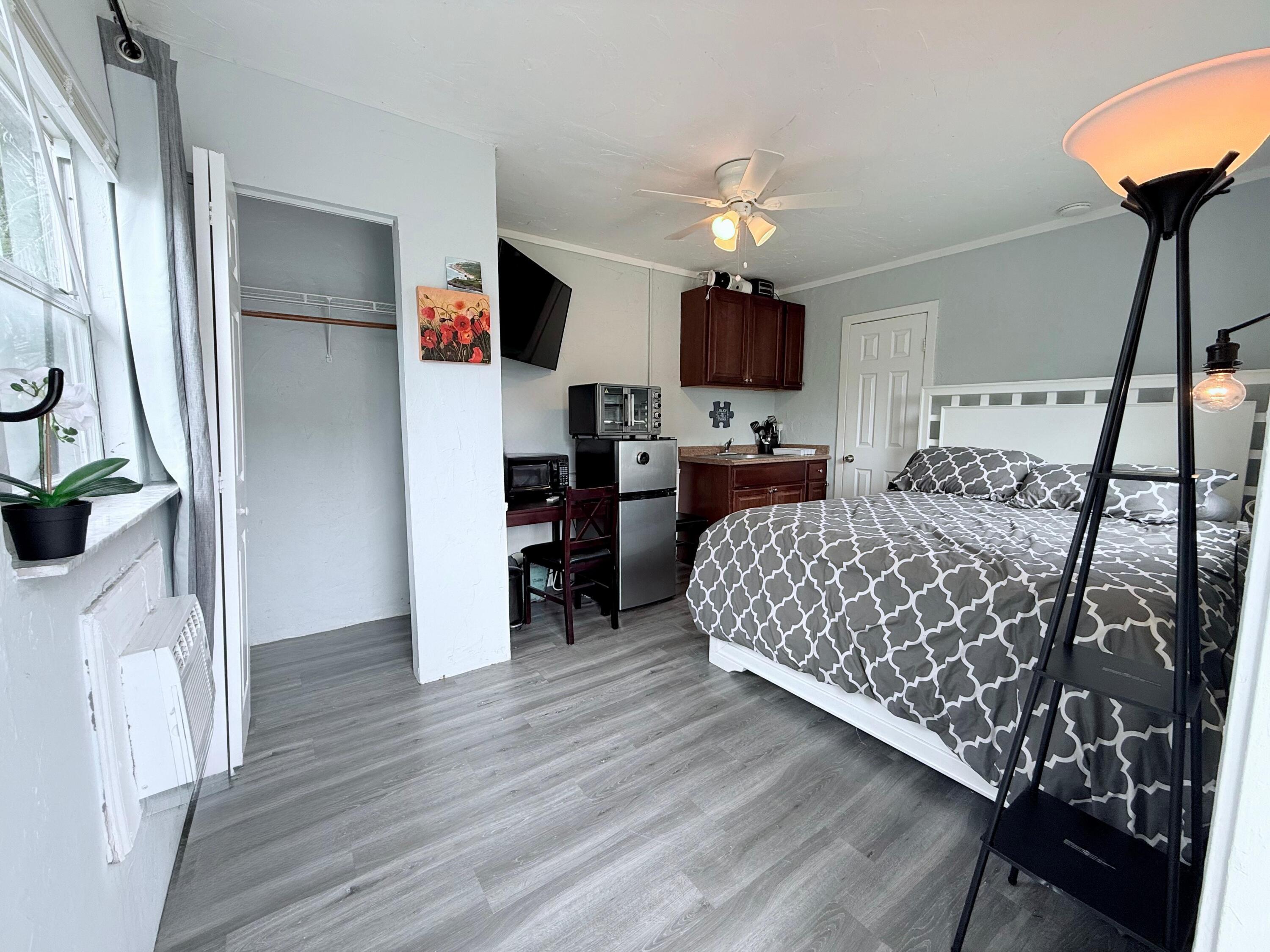 517 Kanuga Drive, Unit 4 West Palm Beach, FL 33401 - Photo 1 of 9 a living room with furniture and a flat screen tv