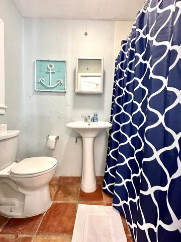 a bathroom with a sink toilet and shower