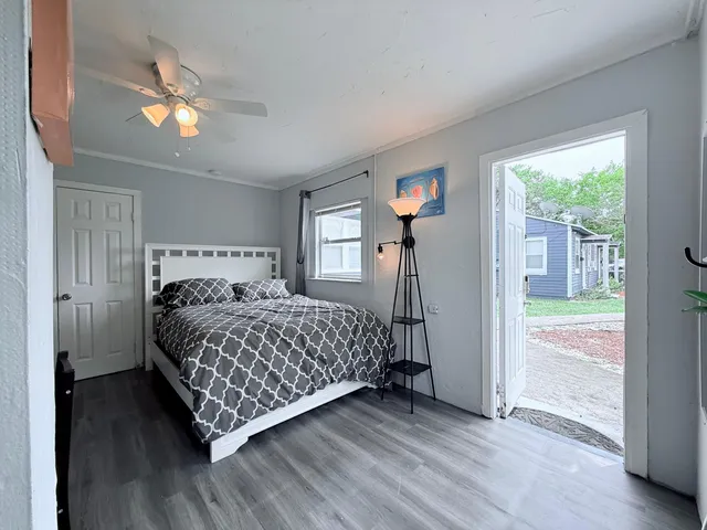 a bedroom with a bed and a chandelier