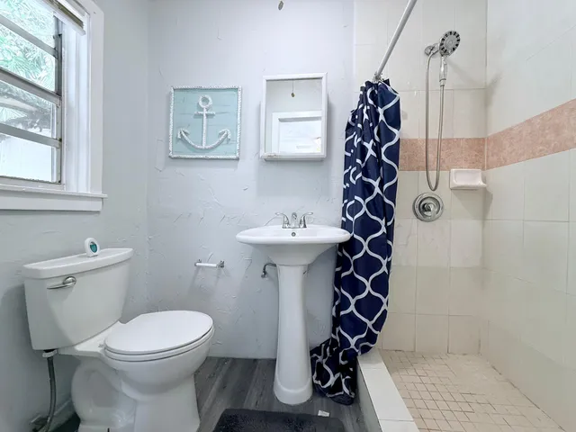 a bathroom with a sink toilet and shower