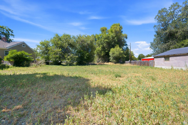 300 East S, Unit 2 Logan, UT 84321 - Photo 30 of 38 Expansive lot featuring mature trees and a partial wood fence