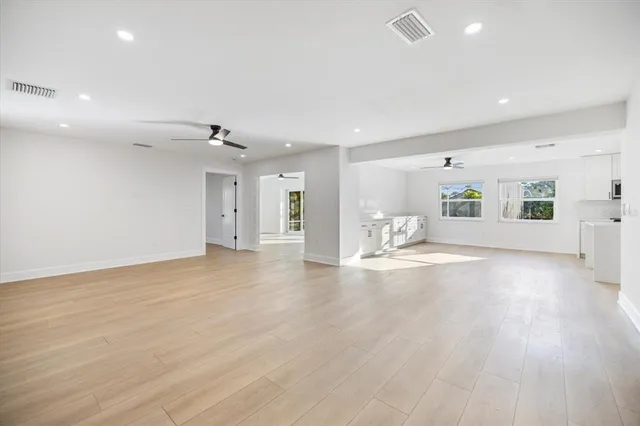 a view of a room with a window and a ceiling fan