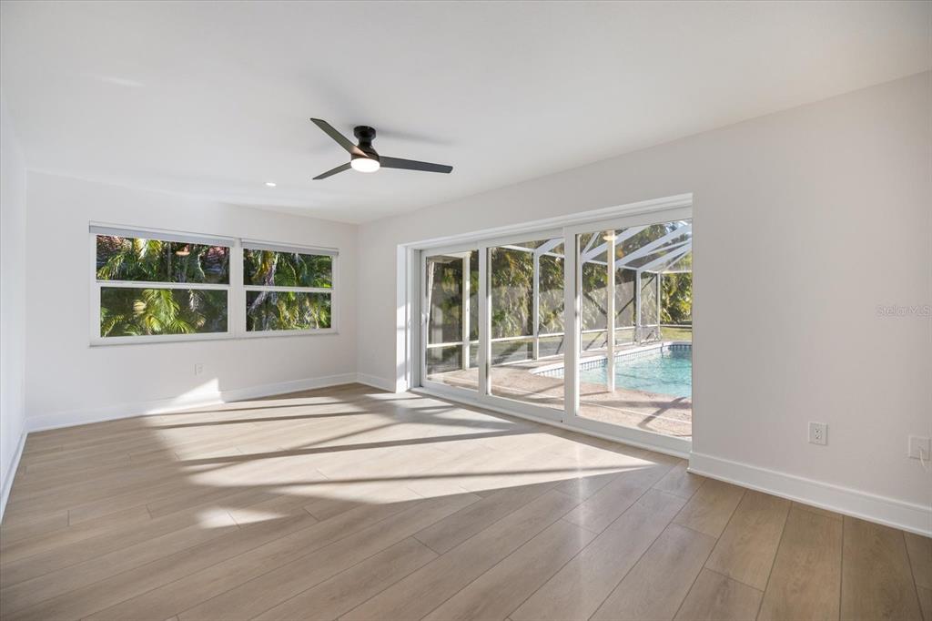 470 Leger Drive Nokomis, FL 34275 - Photo 14 of 51 a view of an empty room with a window and a ceiling fan