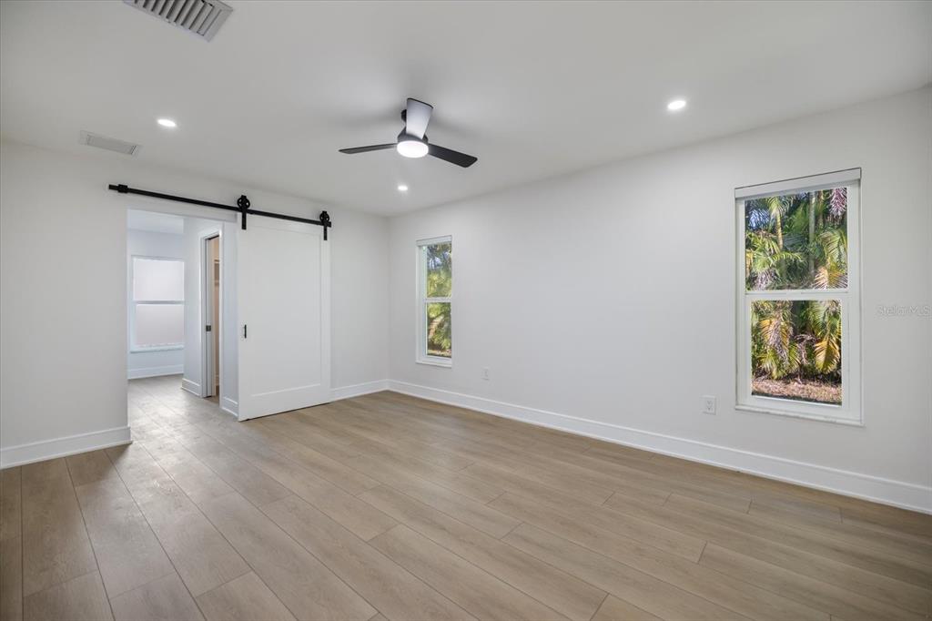 470 Leger Drive Nokomis, FL 34275 - Photo 16 of 51 wooden floor in an empty room with a window