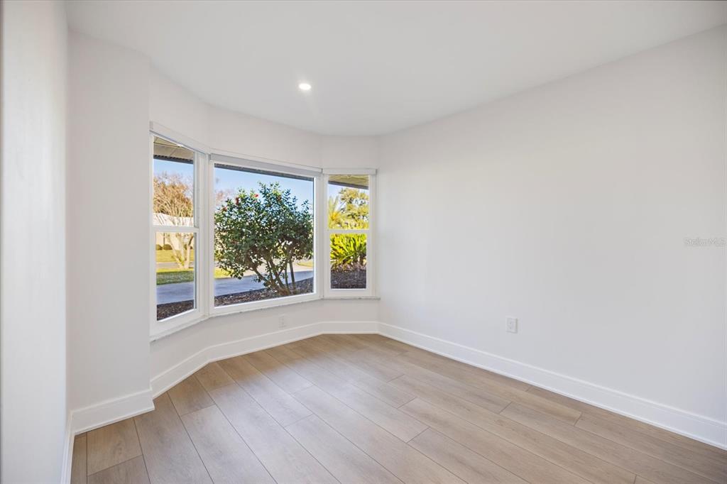 470 Leger Drive Nokomis, FL 34275 - Photo 18 of 51 an empty room with wooden floor and windows
