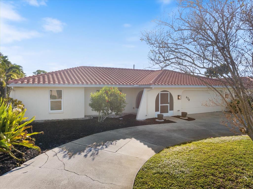 470 Leger Drive Nokomis, FL 34275 - Photo 2 of 51 a front view of a house with a yard