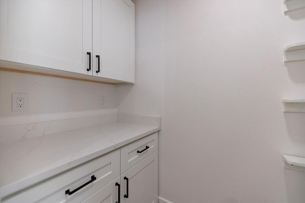 470 Leger Drive Nokomis, FL 34275 - Photo 22 of 51 a view of storage and utility room with racks on the wall