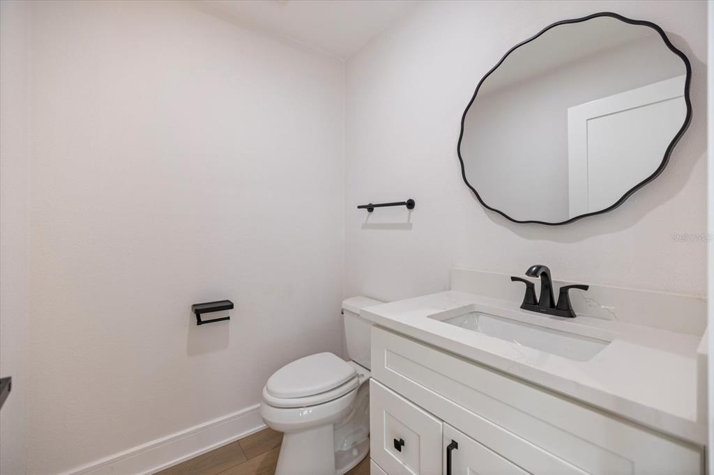 470 Leger Drive Nokomis, FL 34275 - Photo 23 of 51 a bathroom with a sink a toilet and a mirror
