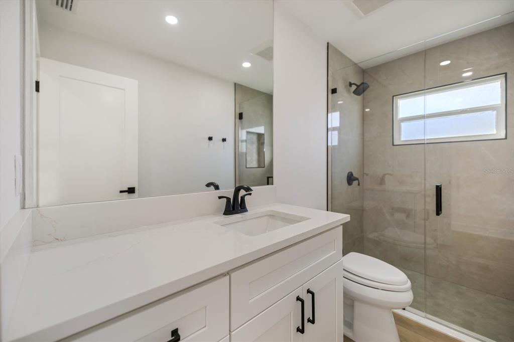 470 Leger Drive Nokomis, FL 34275 - Photo 26 of 51 a bathroom with a sink a toilet and shower