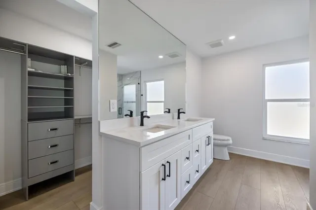a view of walk in closet with empty racks