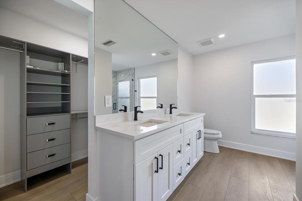 470 Leger Drive Nokomis, FL 34275 - Photo 30 of 51 a bathroom with double vanity sink and mirror