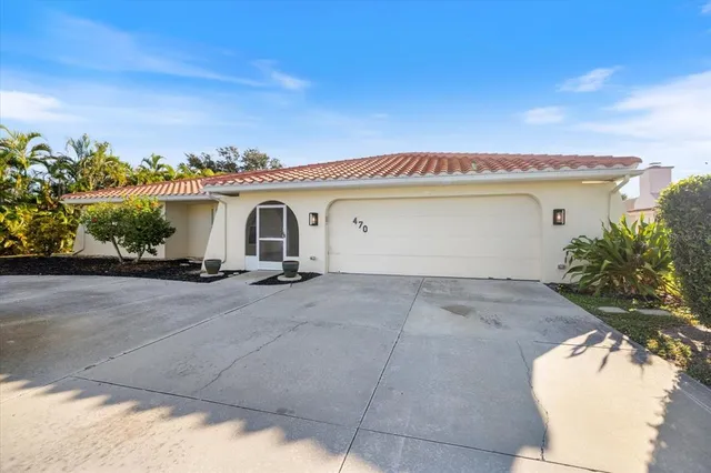 a view of a house with a yard and a garage