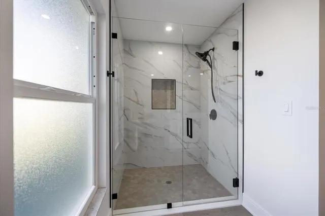 a bathroom with a double vanity sink and mirror with toilet