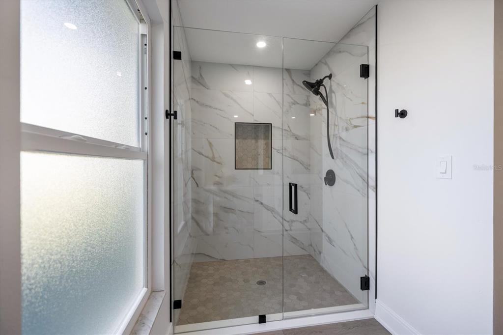 470 Leger Drive Nokomis, FL 34275 - Photo 32 of 51 a bathroom with a glass shower door