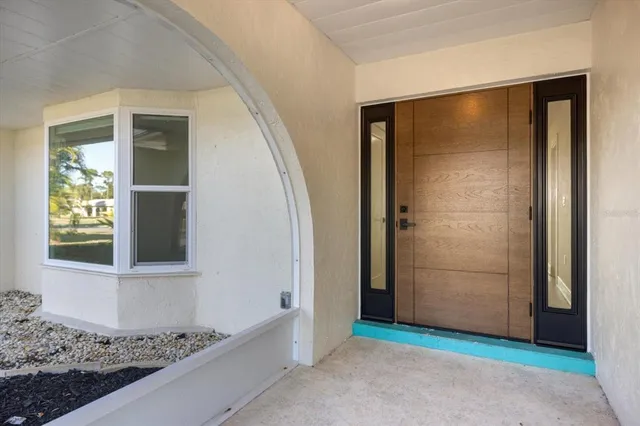 an empty room with wooden floor and closet area