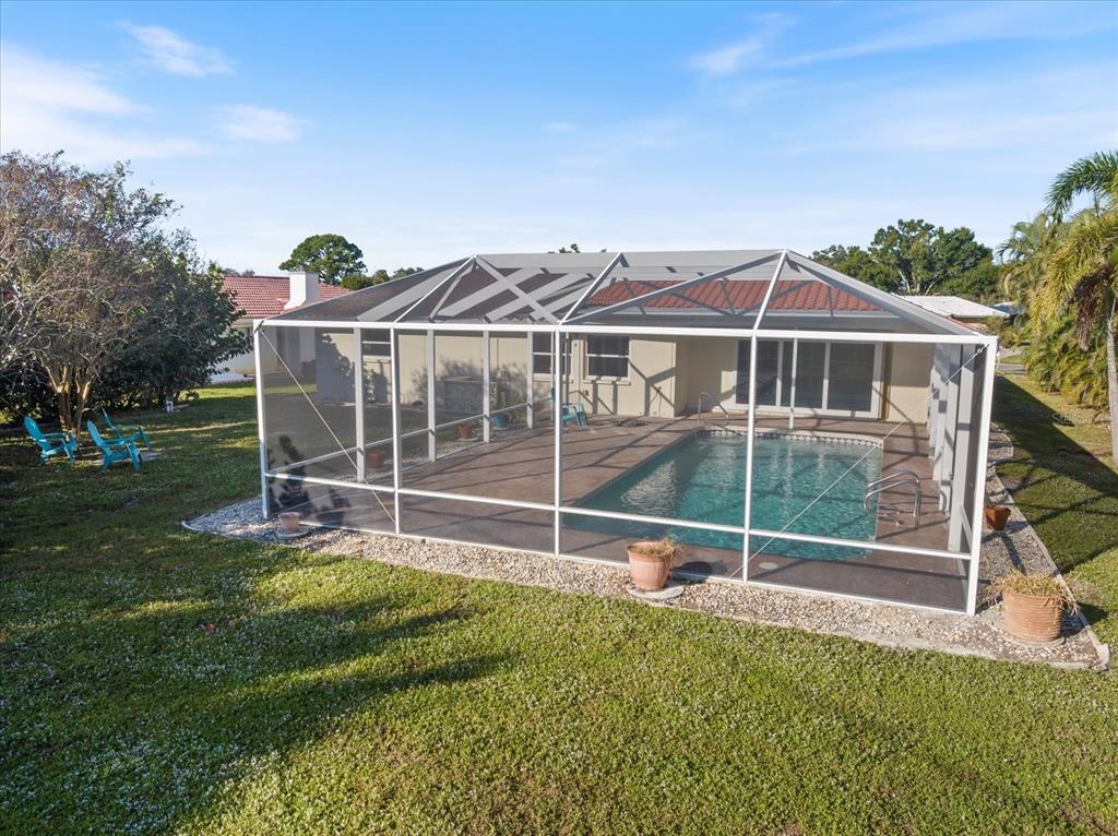470 Leger Drive Nokomis, FL 34275 - Photo 41 of 51 a view of a house with a backyard and a garden