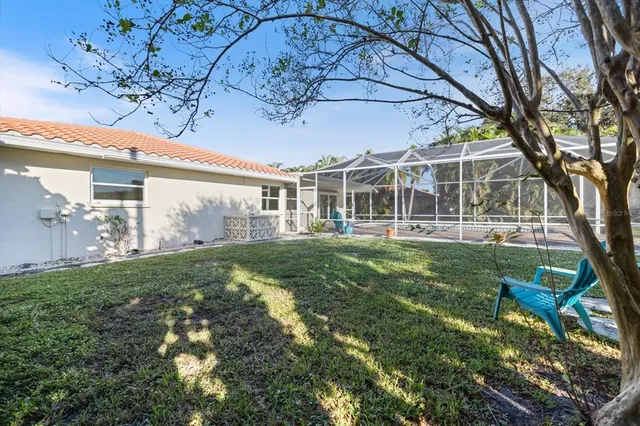 a view of a house with backyard sitting area and garden