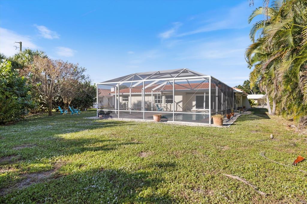 470 Leger Drive Nokomis, FL 34275 - Photo 44 of 51 a view of a house with a big yard and large trees