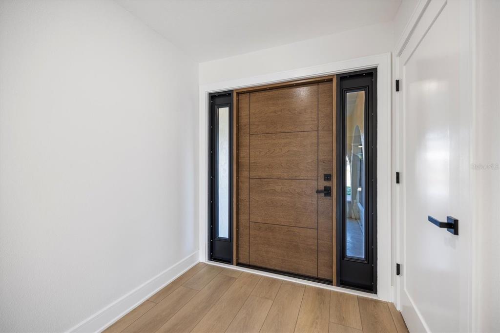 470 Leger Drive Nokomis, FL 34275 - Photo 5 of 51 an empty room with wooden floor and closet area