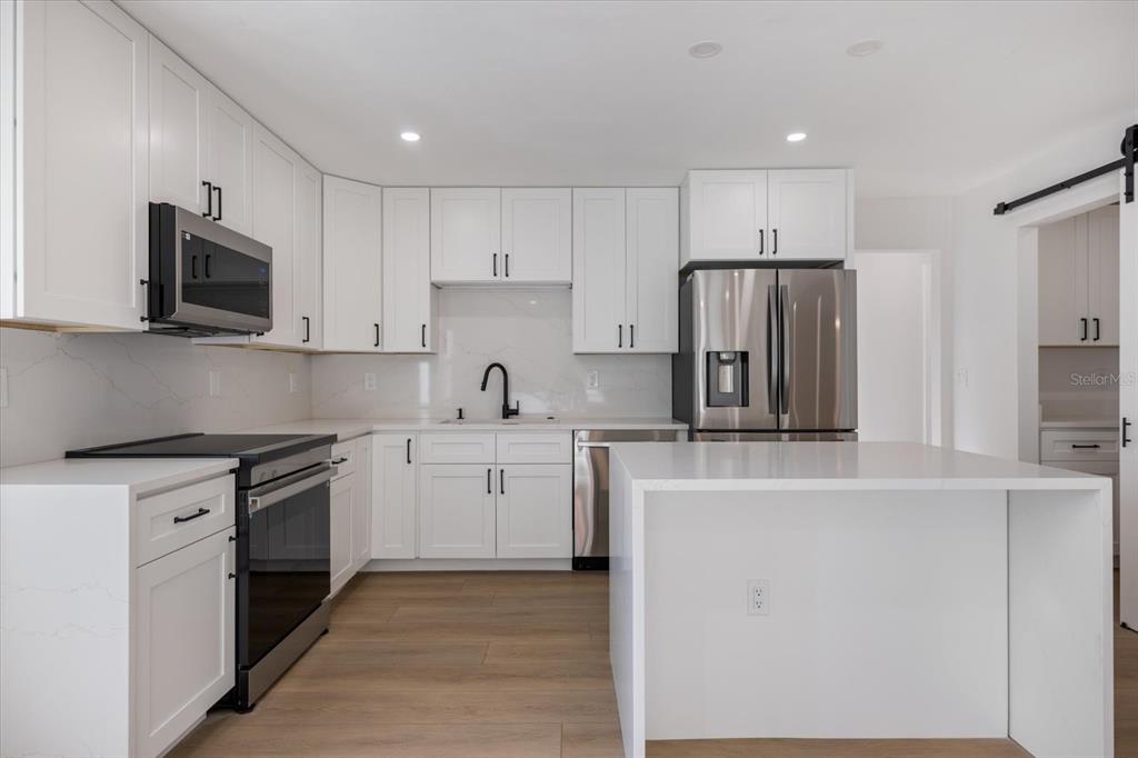 470 Leger Drive Nokomis, FL 34275 - Photo 7 of 51 a kitchen with cabinets stainless steel appliances and a counter top space