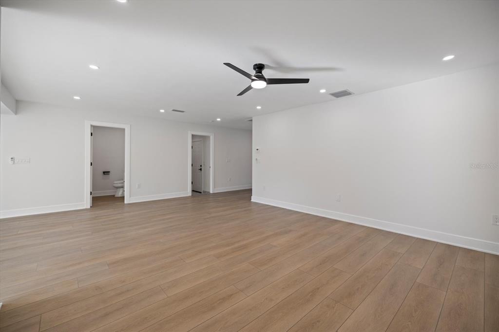 470 Leger Drive Nokomis, FL 34275 - Photo 9 of 51 an empty room with wooden floor and windows