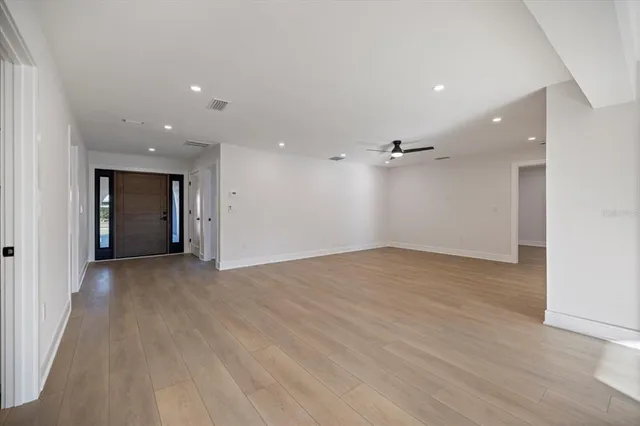 a view of kitchen with stainless steel appliances kitchen island refrigerator stove and a sink