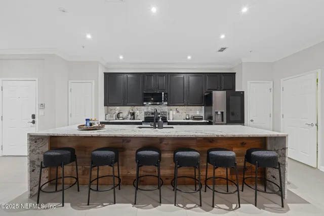 a large kitchen with a table and chairs