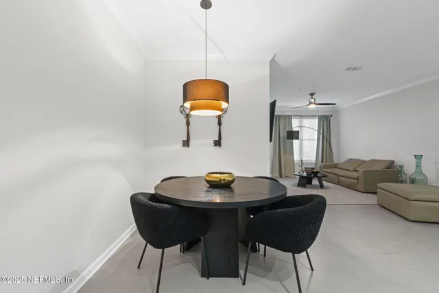 a dining room with furniture and window
