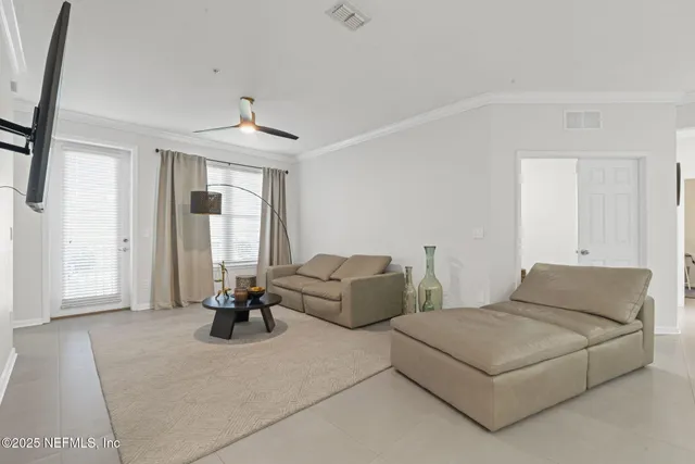 a living room with furniture and kitchen view