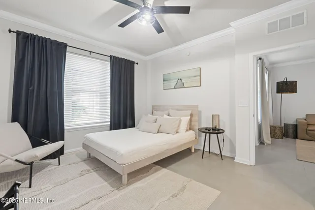 a bedroom with a bed and ceiling fan