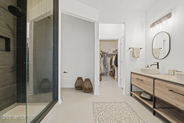 a bathroom with a double vanity sink and a mirror