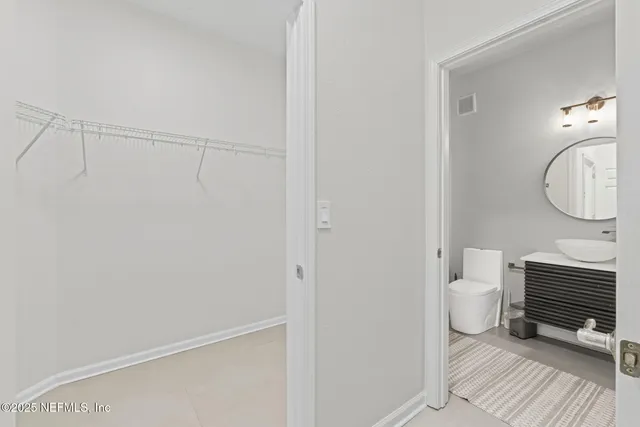 a balcony with chairs and with potted plants